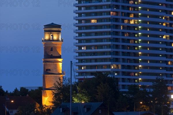 Maritim Hotel and the old lighthouse in the port of Travemuende at dusk