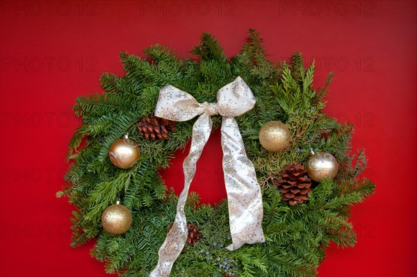Christmas wreath hanging on red door