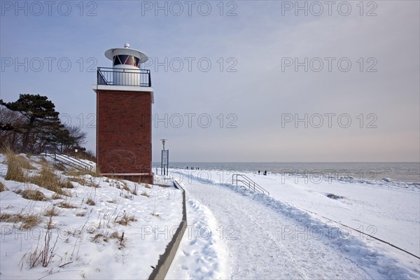The Olhoern lighthouse in the snow in winter at Wyk auf Foehr on the island of Foehr