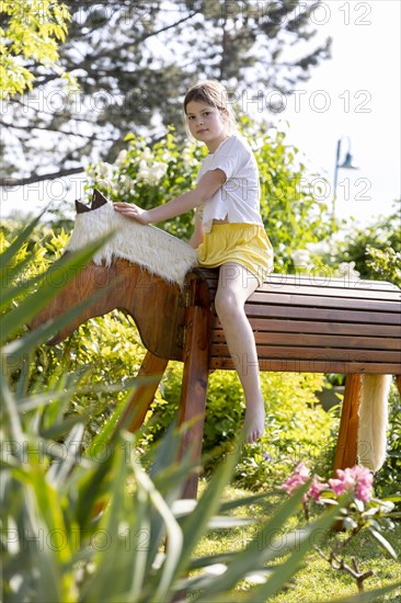 Girl gymnastics on a wooden horse