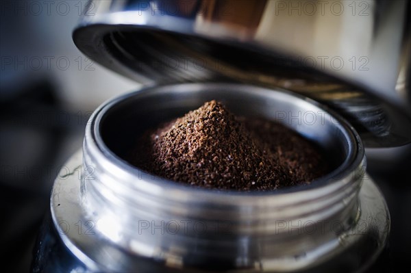 Symbolic photo on the subject of coffee. Ground coffee lies in an espresso machine. Berlin