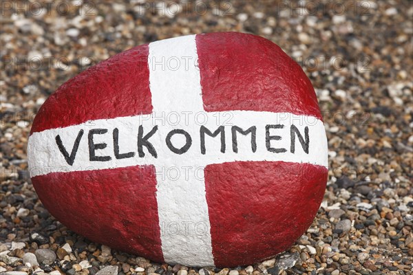 Painted stone with flag of Denmark and inscription Velkommen