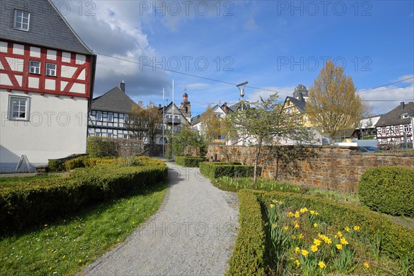 Reading garden and view of townscape with church towers of Hachenburg