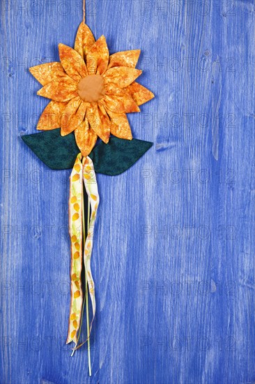 Fabric flower on blue background