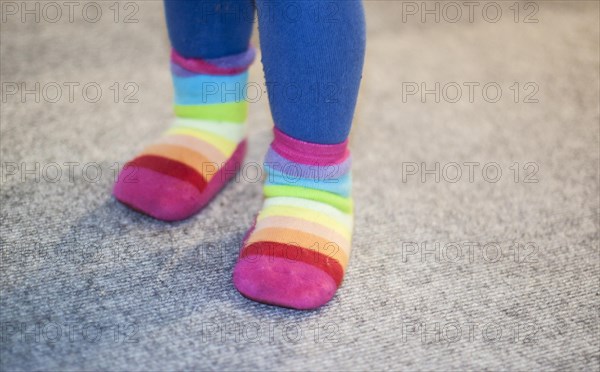 Colourful socks on the feet of a three-year-old child