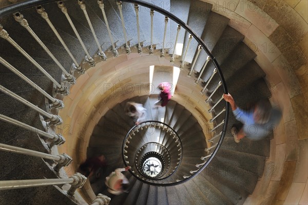 Tourists climbing spiral staircase inside the lighthouse Phare des Baleines on the island Ile de Re