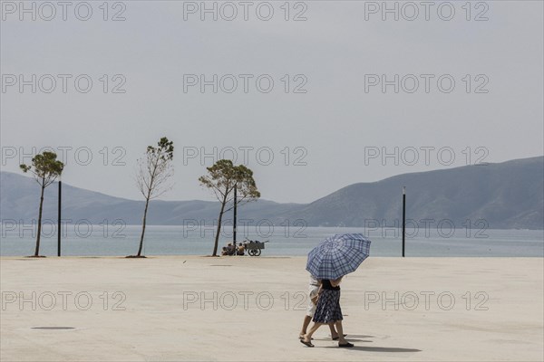 Two people with a parasol