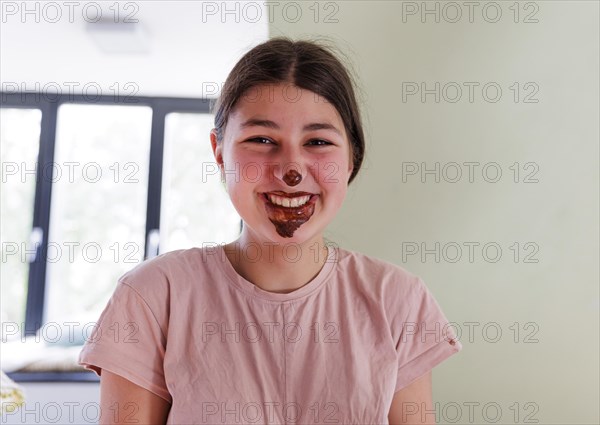 Girl with a chocolate-smeared mouth