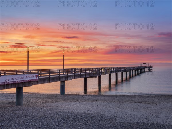 Pier on the beach of the Baltic Sea at sunset