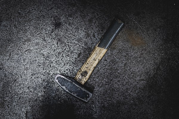 A hammer lying on a workbench