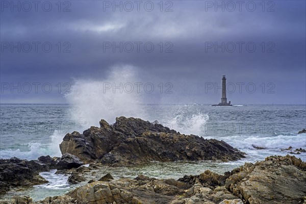 Wave crashing on rock and Phare de La Hague