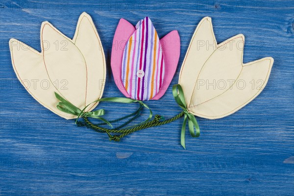 Three fabric tulips on a blue background