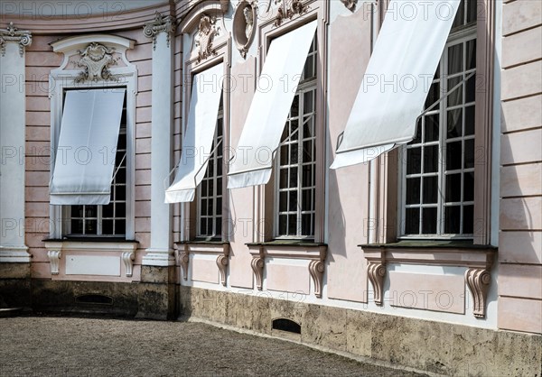 Windows of the Amalienburg with awnings in Nymphenburg Palace Park