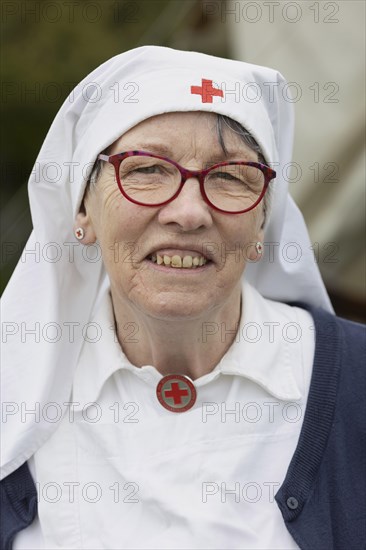 Volunteer of the Red Cross presents a historical outfit.