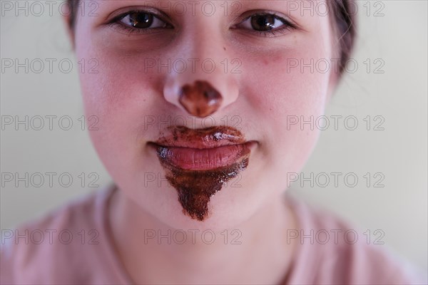 Girl with a chocolate-smeared mouth