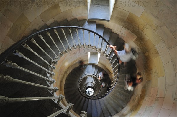 Tourists climbing spiral staircase inside the lighthouse Phare des Baleines on the island Ile de Re