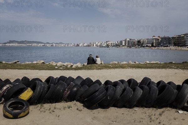 An elderly couple sitting on the beach of Durres