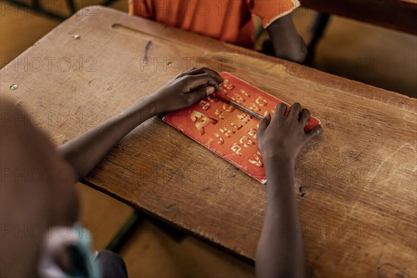 Child in a school class in a settlement for refugees