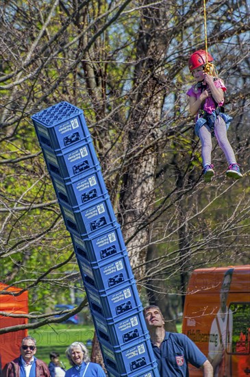Child secured by rope falls while building tower out of beer crates