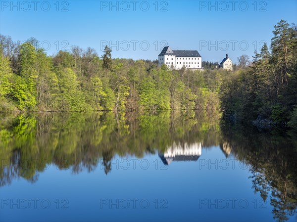 Burgk Castle reflected in the Burhkhammer Dam on the River Saale in spring