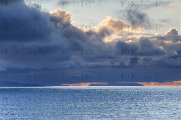 Low-lying rain clouds drift over the Summer Isles and the open waters of the blue Atlantic