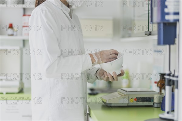 A prescription worker cleans a fan tray