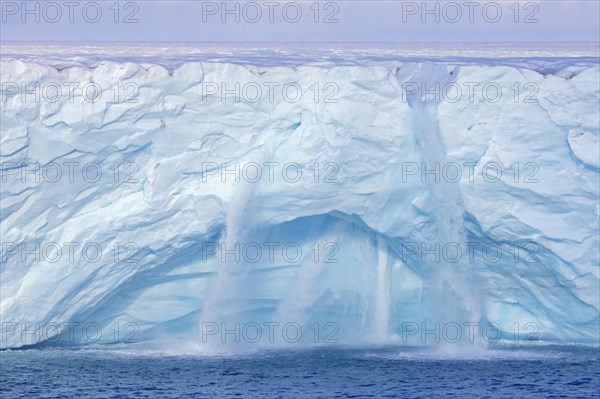 Waterfalls at edge of the Brasvellbreen glacier from the ice cap Austfonna debouching into the Barents Sea