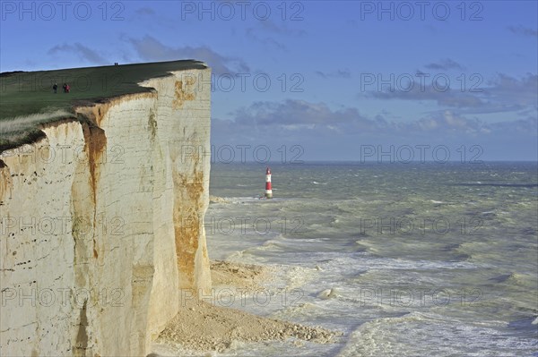 View over the eroded white chalk cliffs and lighthouse at Beachy Head