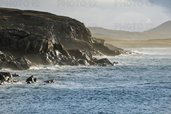 Atmospheric light on the stormy rocky coast of western Scotland