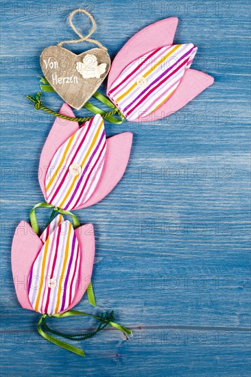 Three fabric tulips on a blue background