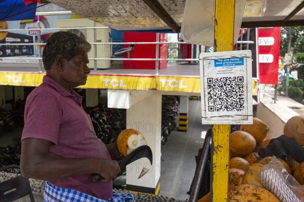 QR code for cashless payment at the stall of a coconut vendor in Trichy