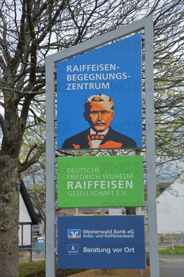 Sign and poster with Friedrich Wilhelm Raiffeisen founder of the society and cooperative bank