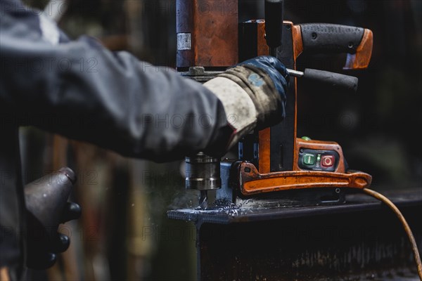 A hole is drilled into a steel beam