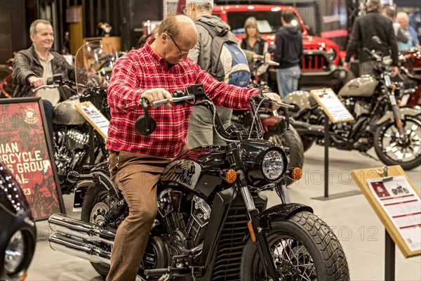 Man sits test on motorbike Indian Scout Bobber Twenty