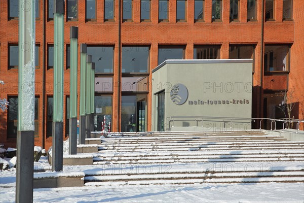 District office with snow in winter with coat of arms and inscription Main-Taunus-Kreis
