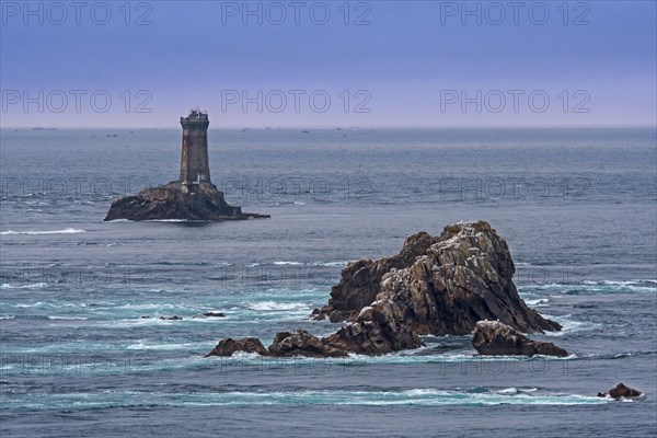 The lighthouse La Vieille in the strait Raz de Sein at dusk at the Pointe du Raz