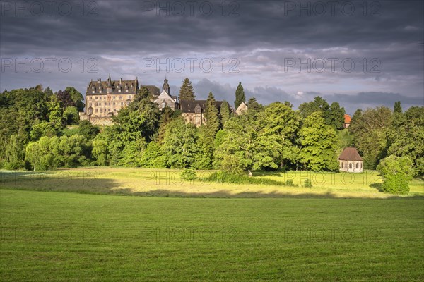Eisenbach Castle and Annen Chapel under dark clouds