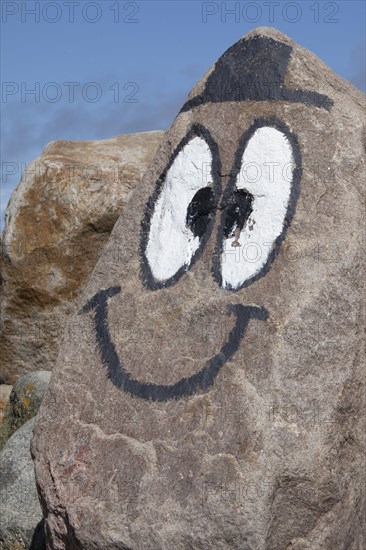Eyes and mouth painted on rock