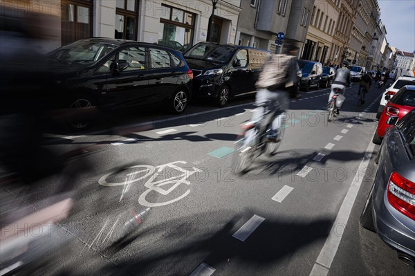 Symbolic photo on the subject of bicycle lanes in the city. Cyclists ride on the bicycle street in Linienstrasse in Berlin Mitte. Berlin