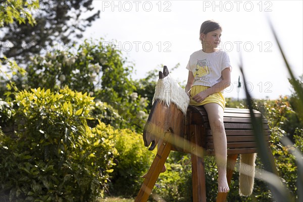 Girl gymnastics on a wooden horse