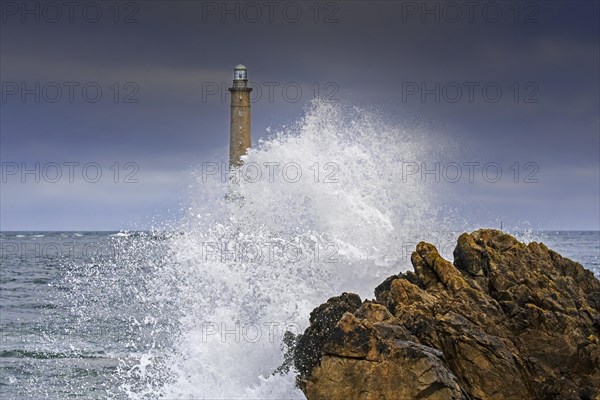 Wave crashing on rock and Phare de La Hague