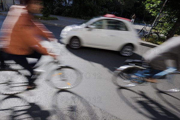 Symbolic photo on the subject of cycling in the city. Cyclists ride on the bicycle lane in Linienstrasse in Berlin Mitte. Berlin