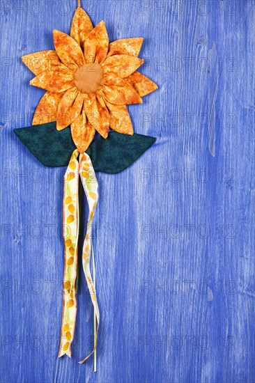 Fabric flower on blue background