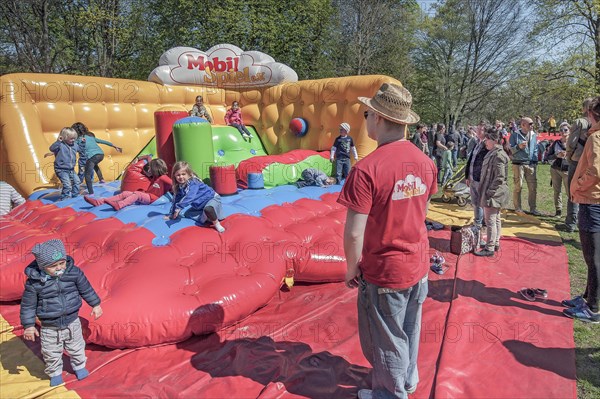 Children in bouncy castle in springtime Luitpoldpark