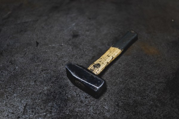 A hammer lying on a workbench