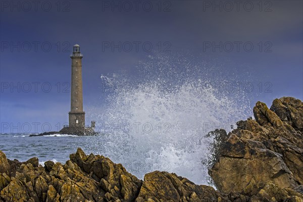 Wave crashing on rock and Phare de La Hague