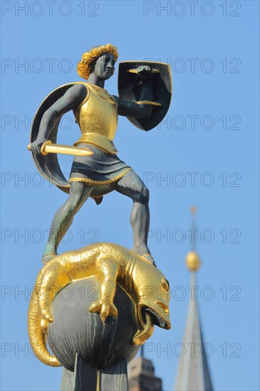 Sculpture Saint George with shield and sword at St. George's Fountain and spire