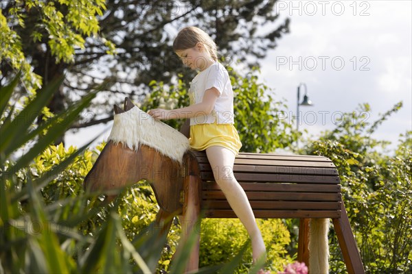 Girl gymnastics on a wooden horse