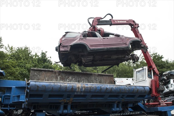 Crushed cars in scrap yard UK