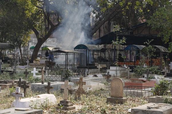 Rubbish is burned at the Indian Christian Cemetery